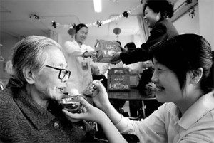 An elderly woman enjoys sweet dumplings at a nursing home in Beijing.