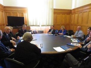 Dave Cheperdak, President, Daniel Fontaine, CEO, & Wendy Miller, home care aide dialougue on seniors care at a round table with a number of MLAs
